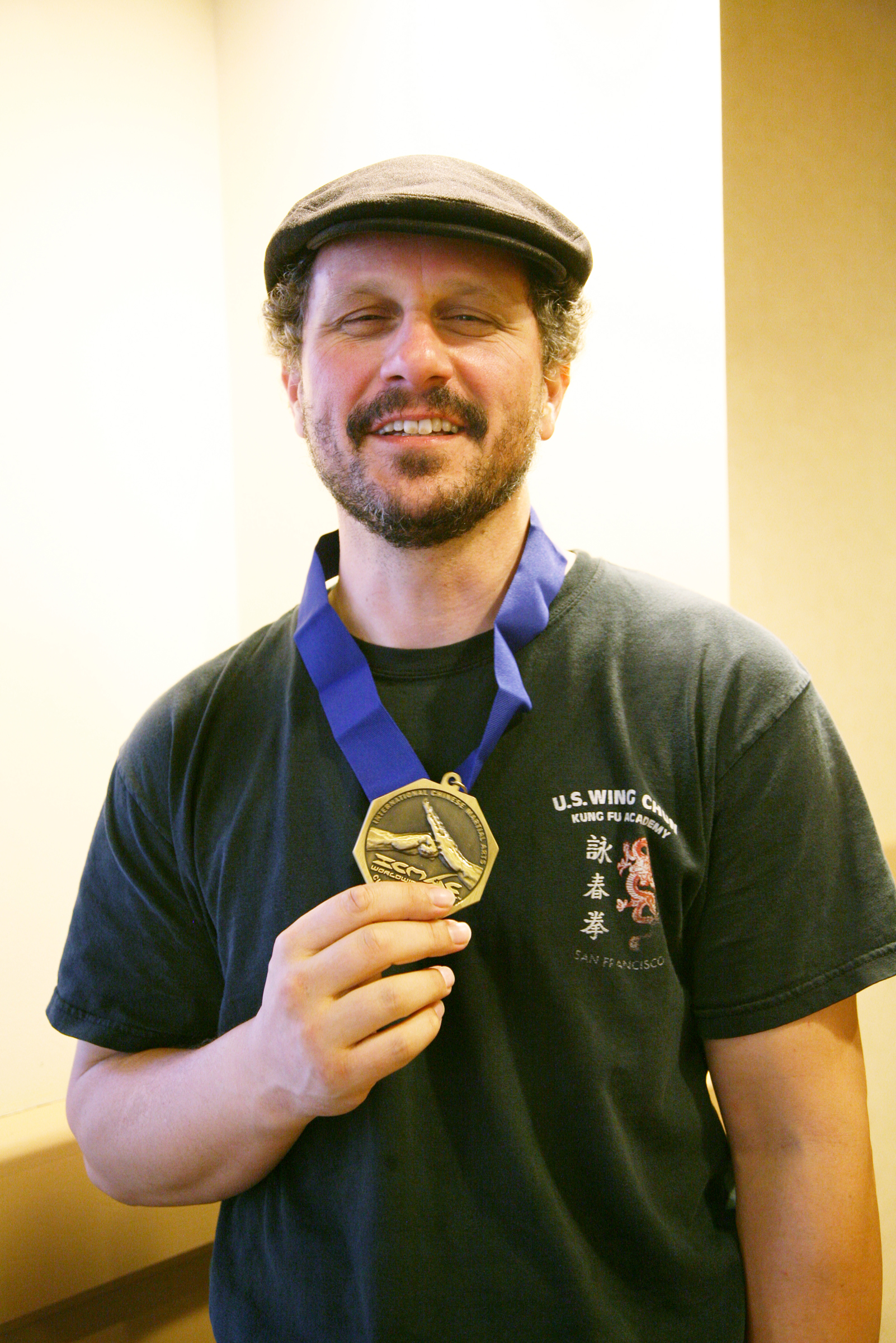 Sifu Brandon holding a medal at a U.S. Wing Chun event